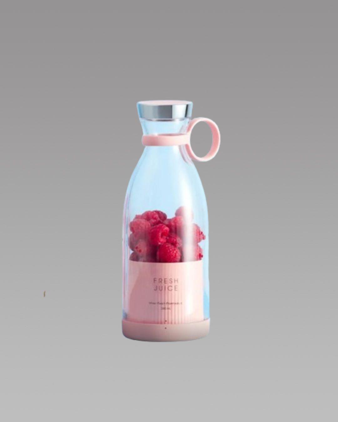 Pink portable juicer bottle with raspberries against gray background