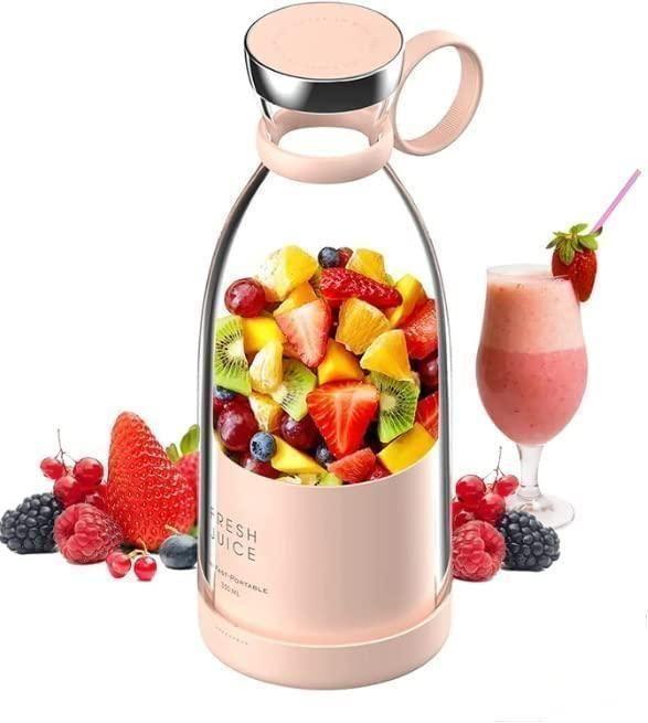 Juicer bottle filled with mixed fruits including strawberries, kiwi and orange pieces with smoothie glass