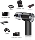 Compact wireless handheld vacuum cleaner with black and transparent parts next to electronic devices and household items